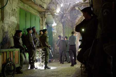 Israeli border police guard the entrances that lead to the Al Aqsa Mosque compound as worshipers make their way to pray in Jerusalem's Old City Friday, Nov. 3, 2000. (AP Photo/Peter Dejong)